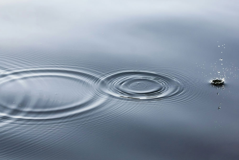 water drops on a calm lake